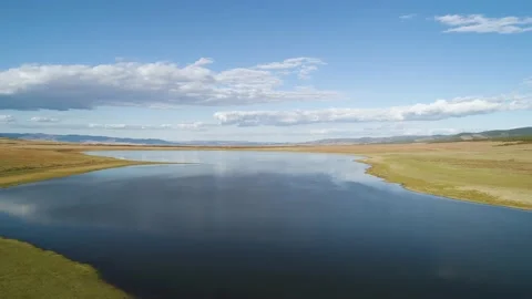 Aerial drone view over sunset lake. Beautiful peaceful sunset lake reflection. Stock Footage 234582041