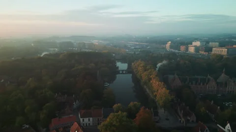 Aerial drone view over tree-lined canal and autumn cityscape in Bruges Vídeo Stock 346675223