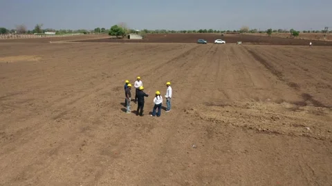 Aerial drone view overlooking six real estate developers wearing yellow Vídeos de archivo 337191265