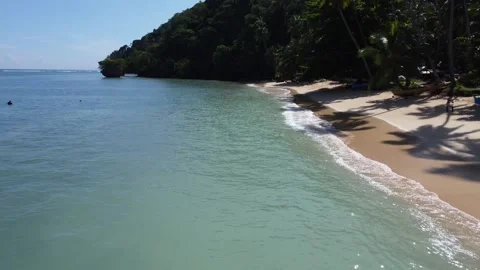 Aerial drone view of Panaraga Beach with tropical jungle ocean waves and isl Vídeo Stock 343441989
