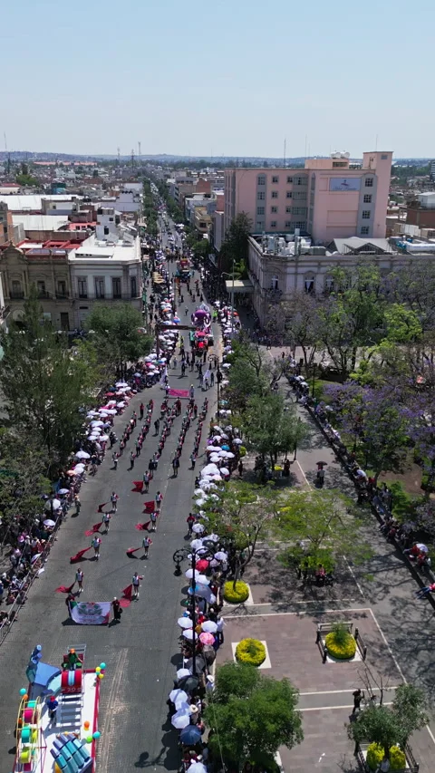 Aerial drone view of a parade marching along a city avenue during the San Stock Footage 342062587