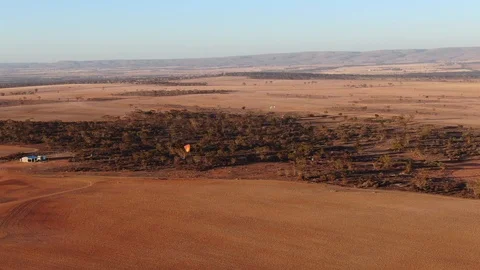 Aerial drone view of paramotor having fun gliding and flying in the air Stock Footage 117129788