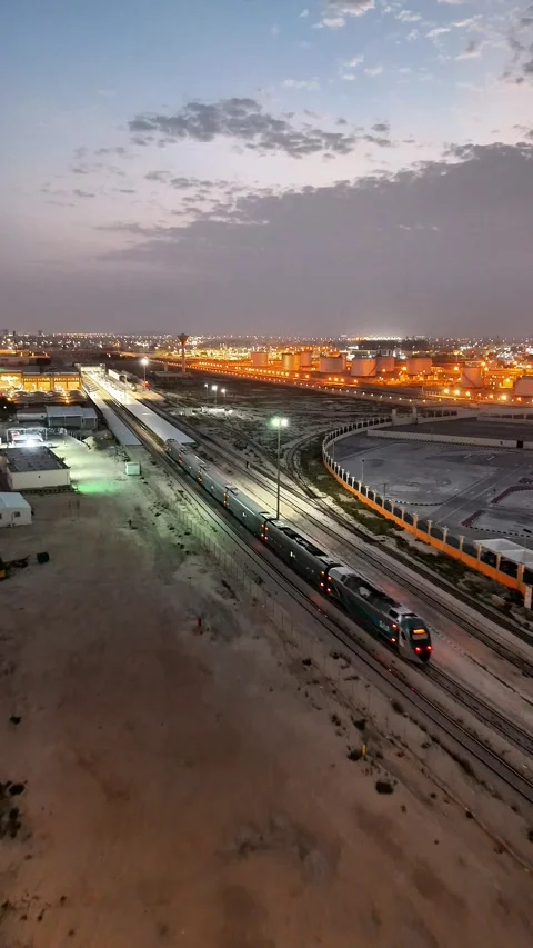 Aerial Drone View of Passenger Train Approaching Station at Dusk in Saudi Arabia Stock Footage 331029379