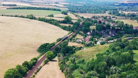 Aerial Drone View of Passenger Train Passing Rural Village in Wiltshire England 库存影片 341920447