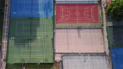 Aerial drone view passing over some tennis and indoor soccer courts Stock Footage 218384277