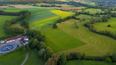 Aerial drone view of patchwork farmland, rapeseed fields and wastewater Stock-Footage 336439144