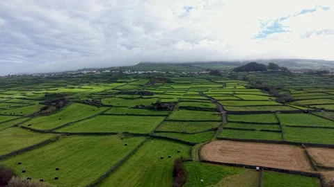 Aerial Drone View Of Patchwork Green Farmland Under Dramatic Clouds On Terceira Stock-Footage 336291673