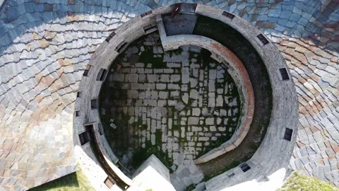 Aerial drone view of paved courtyard of round fortification called Fort de Ronce Stock Footage 247837563