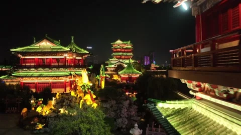 Aerial drone view of Pavilion of Prince Teng brightly illuminated at night Stock Footage 336714914