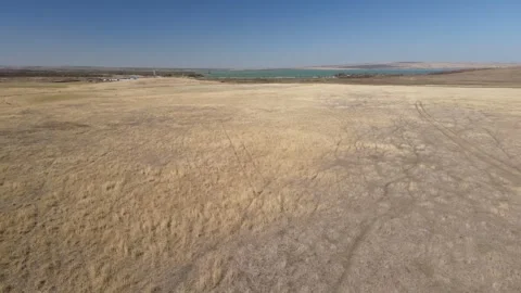 Aerial drone view of people standing near a car in a desert steppe Stock Footage 337479199