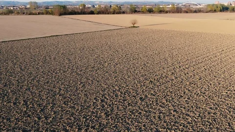 Aerial drone view of plowed fields in dolly zoom Stock Footage 124250728