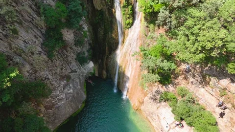 Aerial Drone View of Polylimnio Waterfall and Swimmers Stock-Footage 334900031