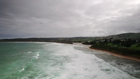 Aerial drone view of powerful ocean waves crashing onto sandy surf beach Vidéo 248883991