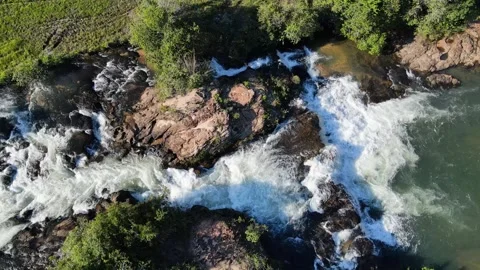 Aerial Drone View of Powerful River Waterfall Cutting Through Rocky Terrain Stock Footage 325837539