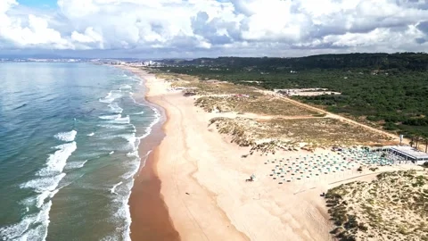 Aerial Drone View of Praia da Morena Beach Coast with Sand, Umbrellas and Ocean Stockbeeldmateriaal 336746499