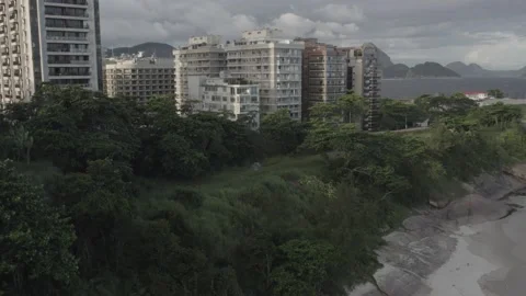Aerial drone view of Praia do Diabo revealing Copacabana beach in the background Stock Footage 231536720