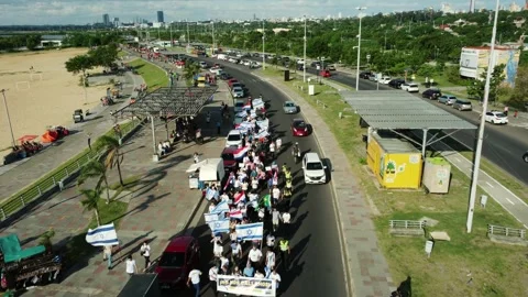 Aerial drone view of public march along Costanera avenue in Asuncion Video stock 335171204