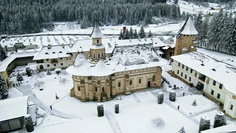 Aerial drone view of Putna Monastery in winter, Romania. Inner yard with walking Video stock 171559813