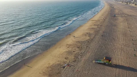 Aerial drone view of a rainbow colored lifeguard tower in Manhattan Beach Stock Footage 317855881