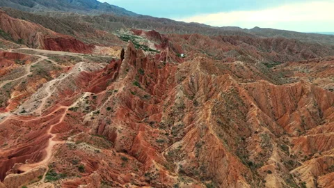 Aerial drone view of red peaks in Skazka Canyon, Kyrgyzstan's scenic landscape. Stock Footage 316828397