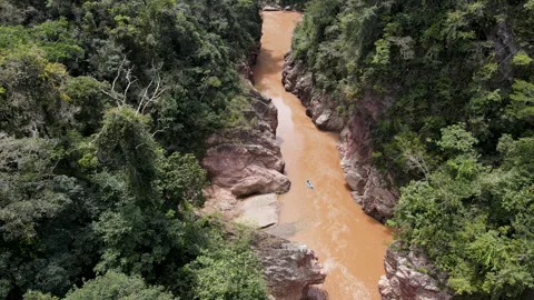 Aerial Drone View of Red Rock Jungle Canyon with Boat on Muddy River Stock Footage 340528705