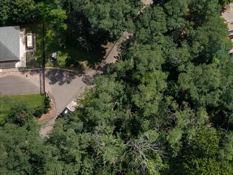 Aerial drone view of residential complex, parking areas, and mature trees in 스톡 사진