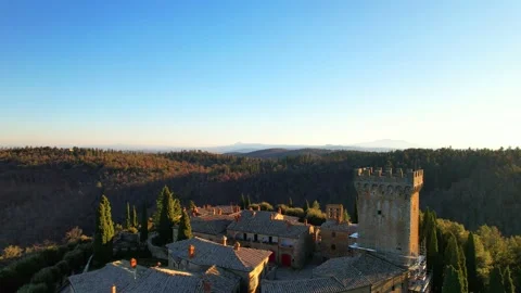Aerial drone view reverse Gargonza Castle Tuscany Italy sunset Stock-Footage 168540423