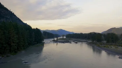 Aerial drone view of the river between tree forest at sunset. Stock Footage 121387415