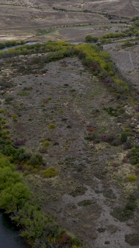 Aerial drone view of river flowing among Valley in dry and mountain landsca.. Stock Footage 282721130