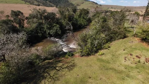 Aerial Drone View of a River Flowing Through Natural Landscape Stock Footage 340894979