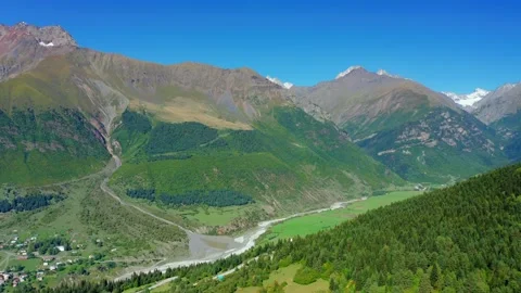 Aerial drone view of a river in a mountain valley against a blue sky. Stock Footage 163607404