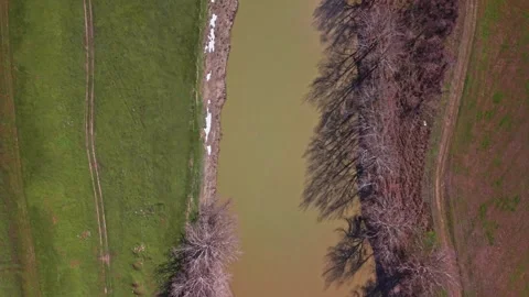 Aerial Drone View of River Through Farmland, Snow, 4K Stock Footage 337940780