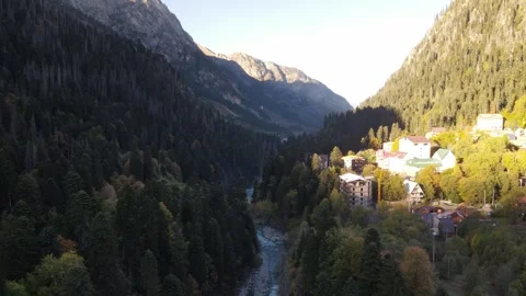 Aerial drone view of a river valley with forest and mountain village Stock Footage 337528817