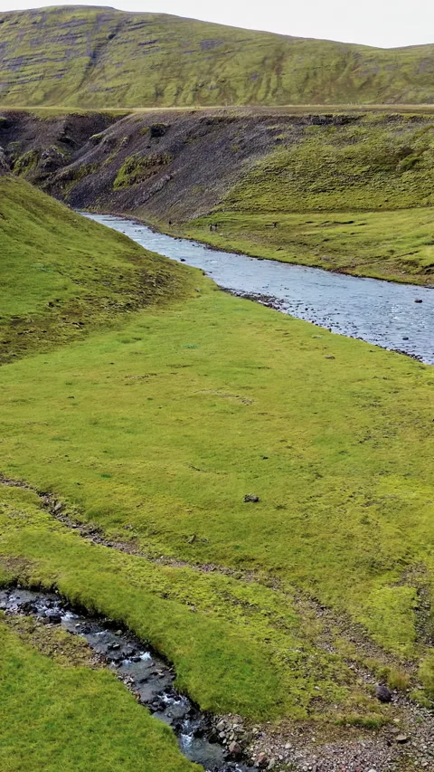Aerial drone view of a river winding through a narrow canyon surrounded by Stock Footage 332304295