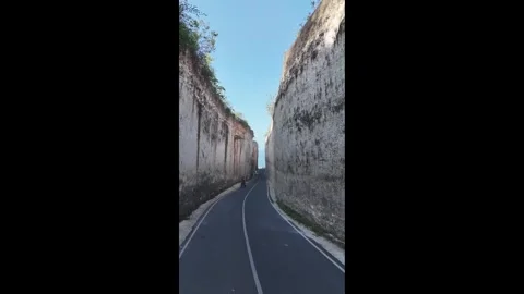 Aerial Drone View of a Road Surrounded by Dramatic Rocky Cliffs in 4K Vídeos de archivo 342485097