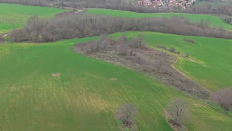 Aerial drone view of rolling green fields and winding rural paths Stock Footage 323322251