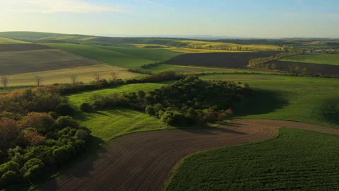 Aerial drone view of rolling Moravian farmland at golden hour, with patchwork Stock-Footage 336615674
