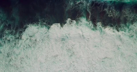 Aerial Drone View of Rolling Ocean Waves Across Tropical Coastline Видео 330589775