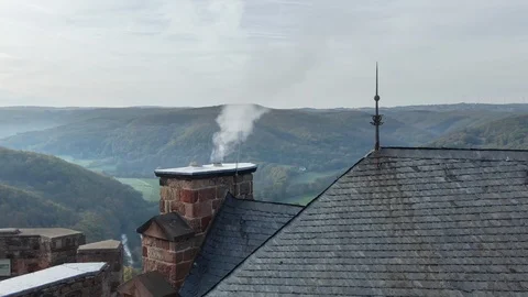 Aerial Drone View Of Roofs Through Chimney Smoke near German European Village 動画素材 118490180