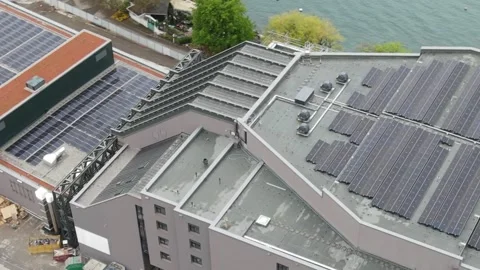Aerial drone view of rooftop solar panels on modern building Stockbeeldmateriaal 332674879