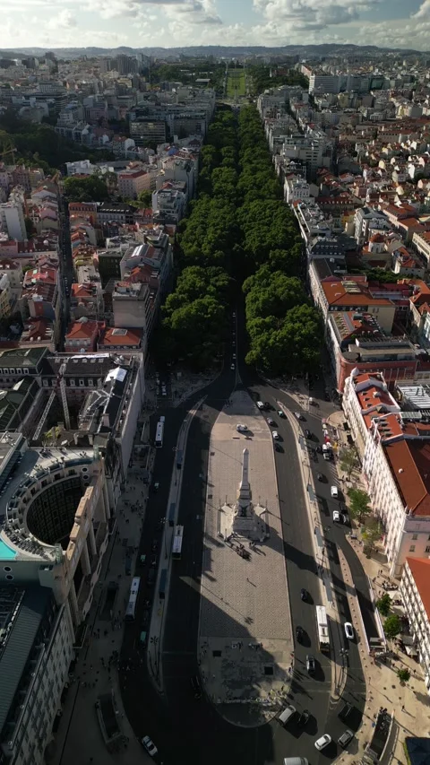 Aerial drone view of Rossio Train Station and Restauradores Square leading up to Stock Footage 275621589