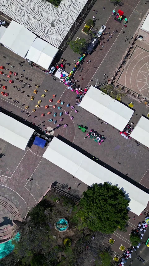 Aerial drone view of rows of white fair tents forming a geometric pattern in Stock Footage 342062515