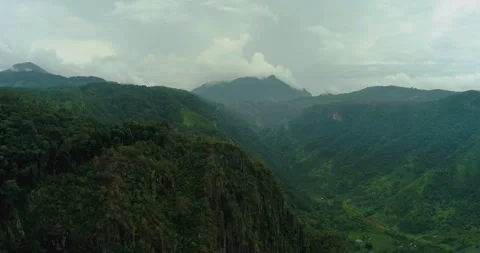 Aerial drone view of rugged cliff landscape covered in thick fog and mist Stock-Footage 333407749