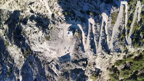 Aerial Drone View of a Rugged Mountain Road Leading to a Summit Watch Tower Stock Footage 340110859