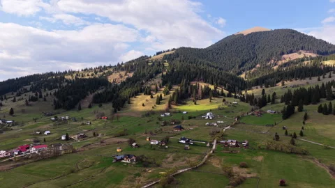 Aerial drone view of a rural hillside filled with scattered houses, grazing Stock Footage 336303353