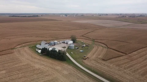 Aerial drone view in rural Iowa with a farm with barns, silos and corn Stock Footage