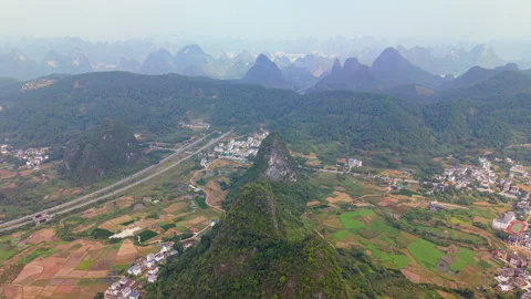 Aerial drone view of Ruyi Peak karst mountains with highway in Guilin, China Stock Footage 325824070