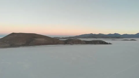 Aerial drone view of Salar de Uyuni salt flat with mountain islands at sunset Stock Footage 175934059