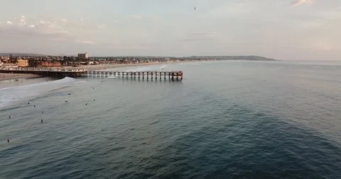 Aerial Drone View of San Diego Pacific Beach Crystal Pier Smooth with Waves Pan Stock Footage