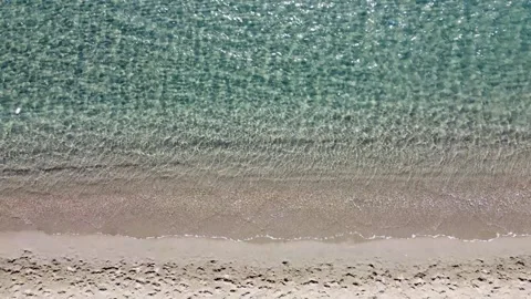 Aerial drone view of sandy beach and sea in summer. Soft waves. Stock Footage 285269153